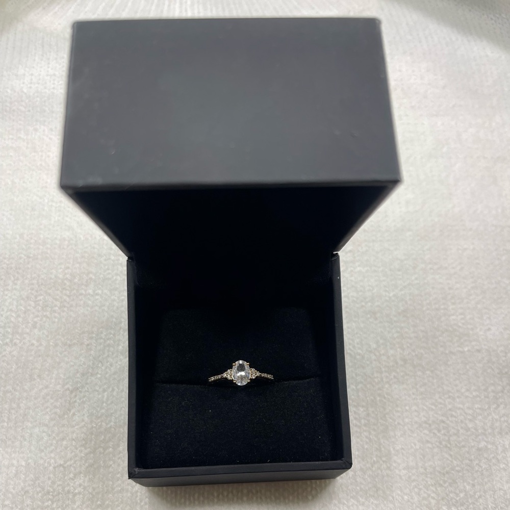 Oval White Lab-Created Sapphire and 1/10 CT. T.W. Diamond Ring in 10K Gold